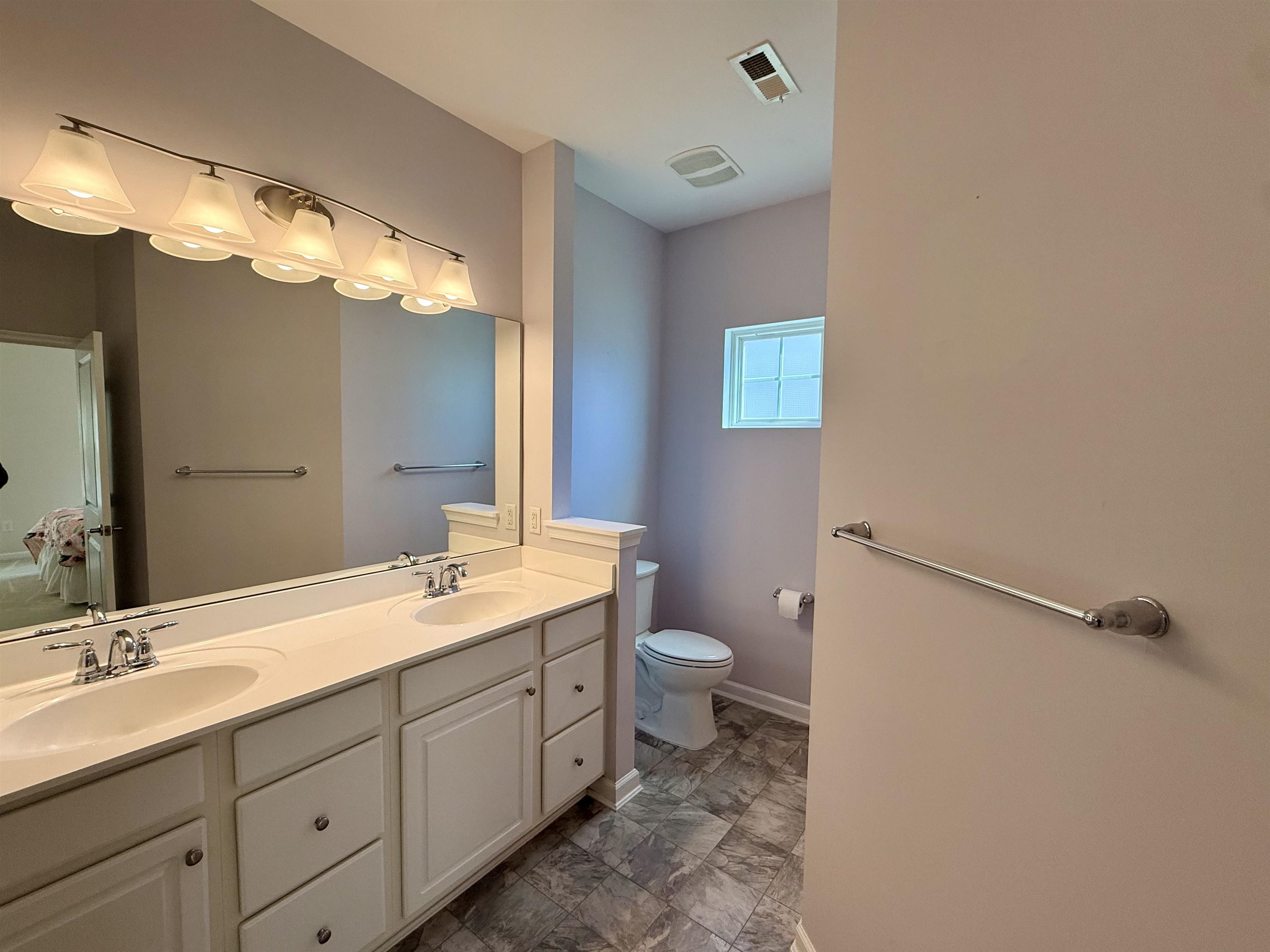 1607 Tidewater Avenue, Unit 1607 Rio Grande, NJ 08242 - Photo 20 of 42 a bathroom with a double vanity sink mirror and toilet