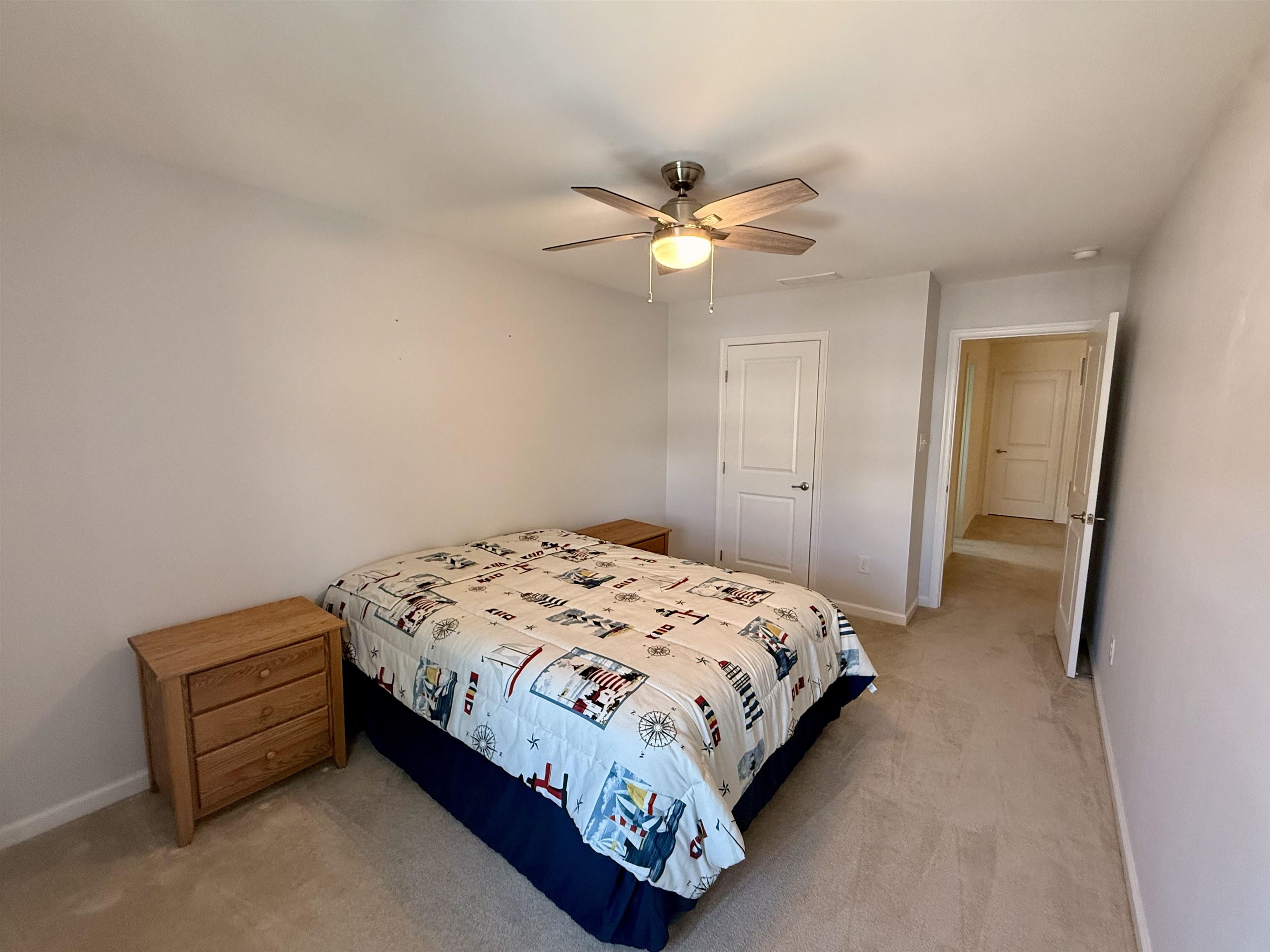 1607 Tidewater Avenue, Unit 1607 Rio Grande, NJ 08242 - Photo 30 of 42 a bedroom with a bed and a chandelier