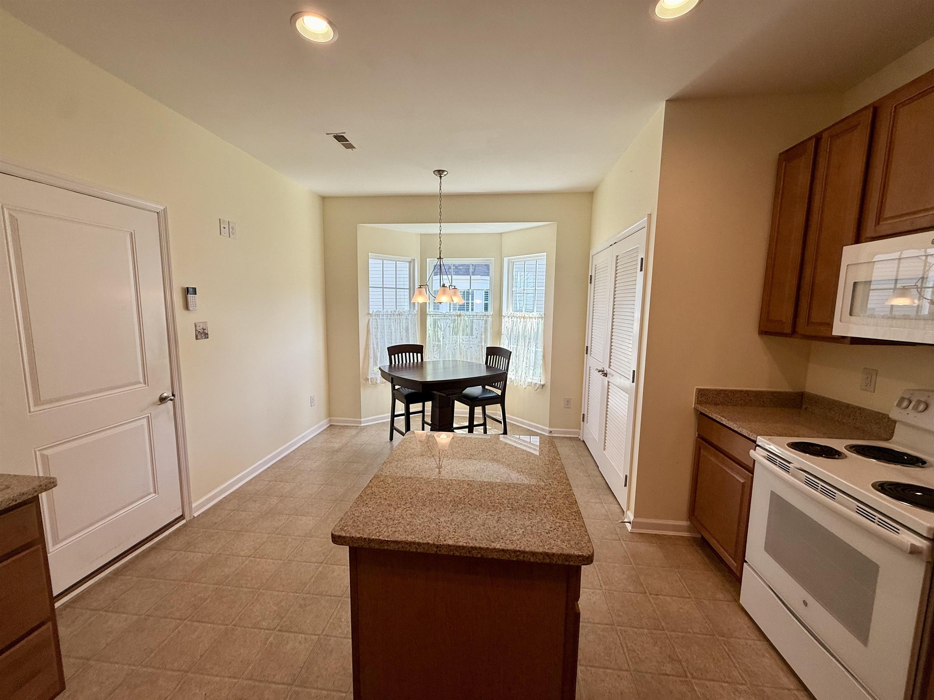 1607 Tidewater Avenue, Unit 1607 Rio Grande, NJ 08242 - Photo 7 of 42 a view of a kitchen area with furniture and wooden floor