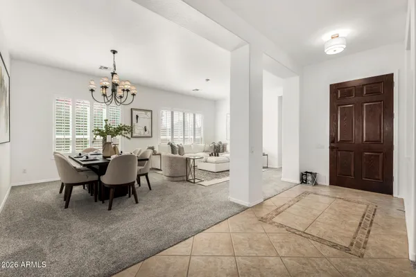 a view of a livingroom with kitchen and couch