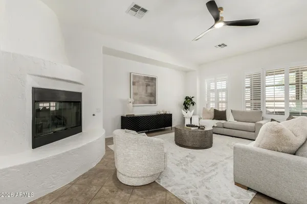 a living room with furniture and wall paintings