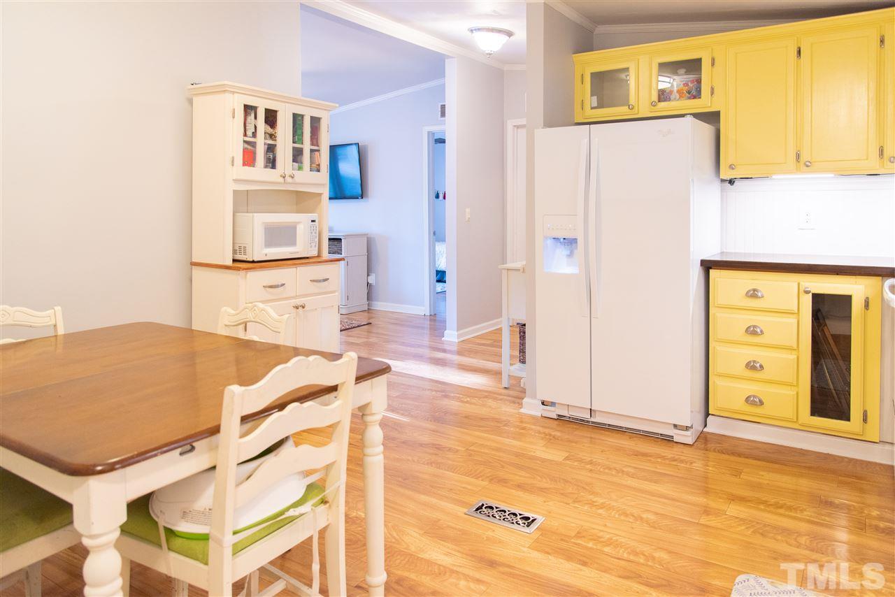 2421 Kearney Road Wake Forest, NC 27587 - Photo 13 of 30 a view of a kitchen with furniture and wooden floor