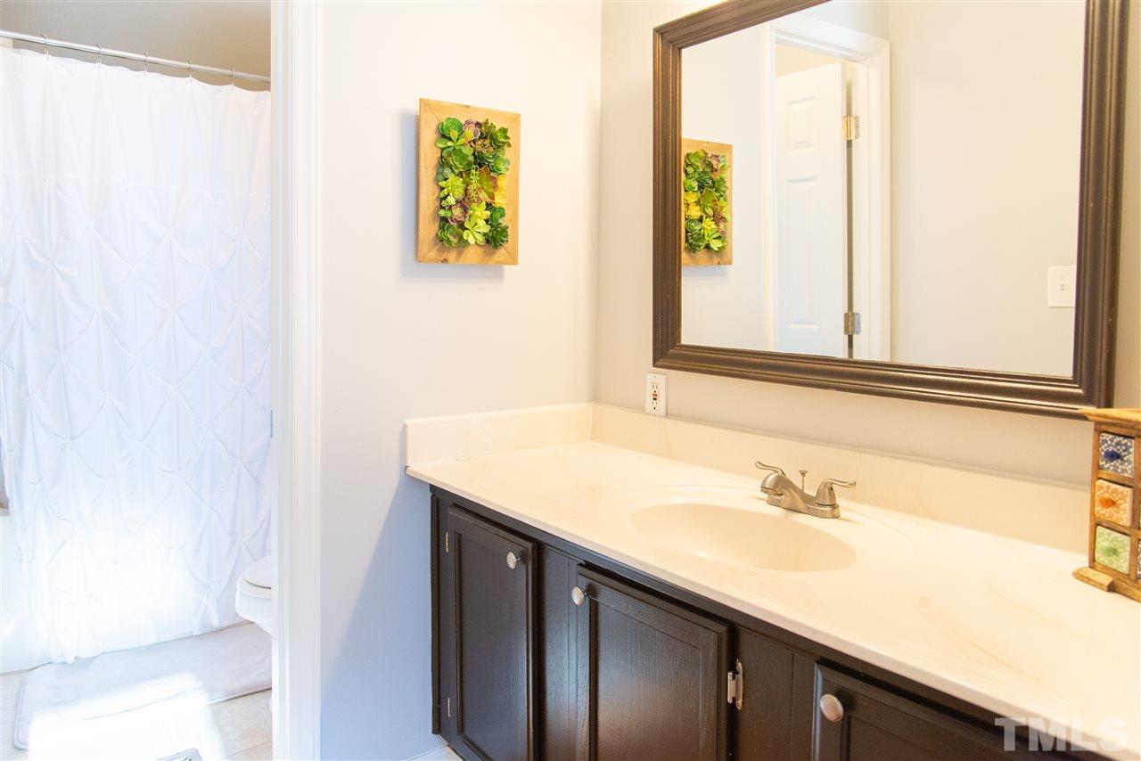 2421 Kearney Road Wake Forest, NC 27587 - Photo 15 of 30 a bathroom with a sink and a mirror