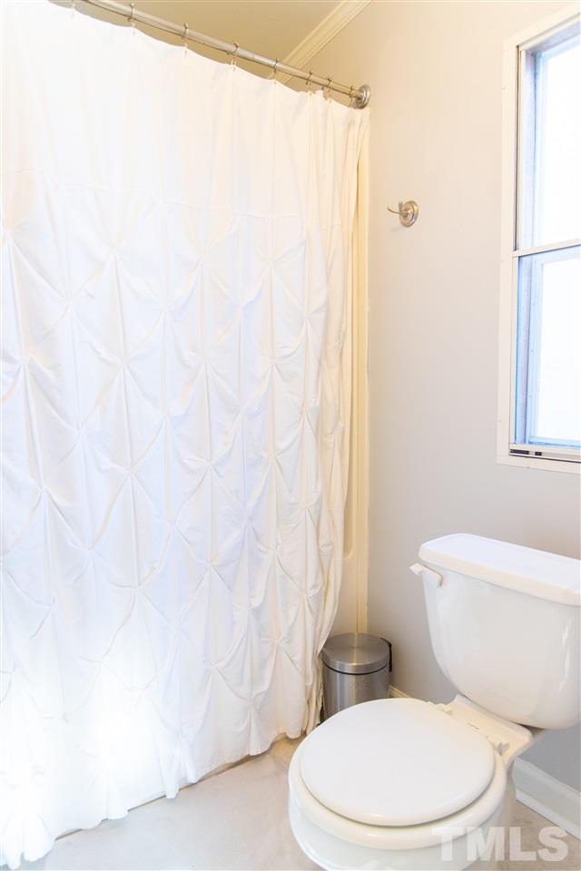 2421 Kearney Road Wake Forest, NC 27587 - Photo 16 of 30 a white toilet sitting next to a shower curtain