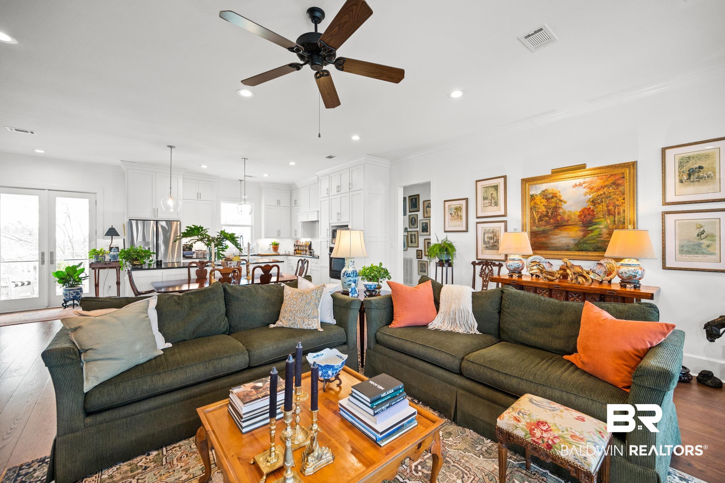 31835 River Road Orange Beach, AL 36561 - Photo 32 of 55 Living room with crown molding, wood-type flooring, french doors, and ceiling fan