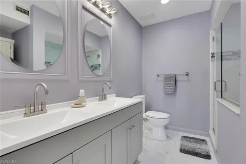 a bathroom with a sink toilet and a mirror