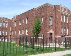 a view of a brick building next to a yard