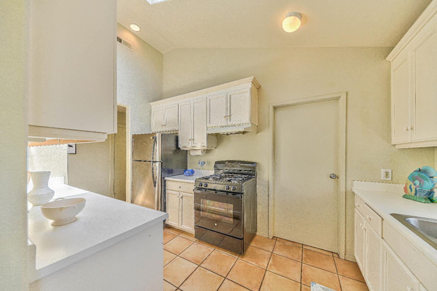 1868 Judson Street Seaside, CA 93955 - Photo 12 of 34 a kitchen with white cabinets and appliances