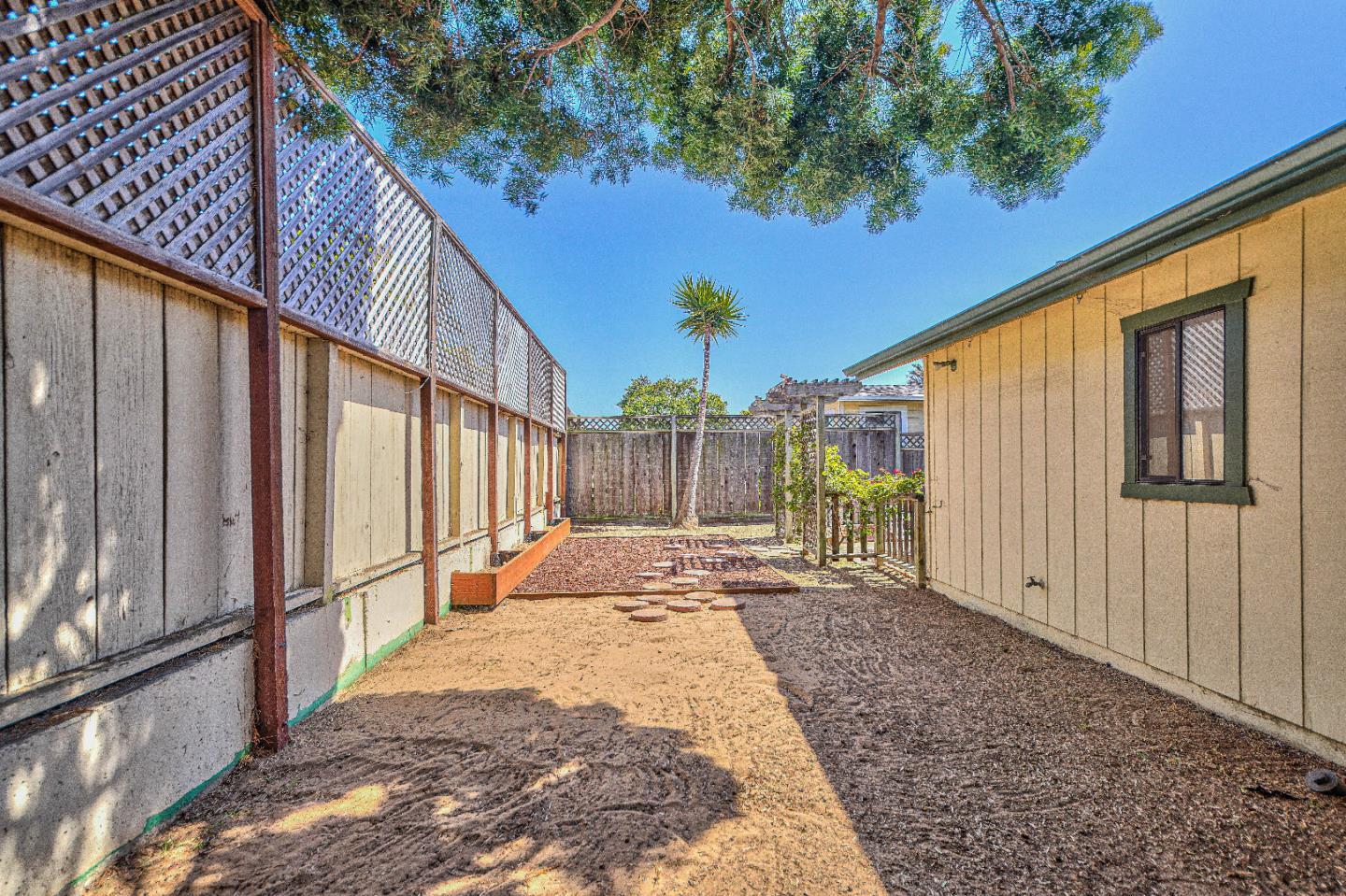 1868 Judson Street Seaside, CA 93955 - Photo 18 of 34 a view of a backyard with wooden fence and large windows