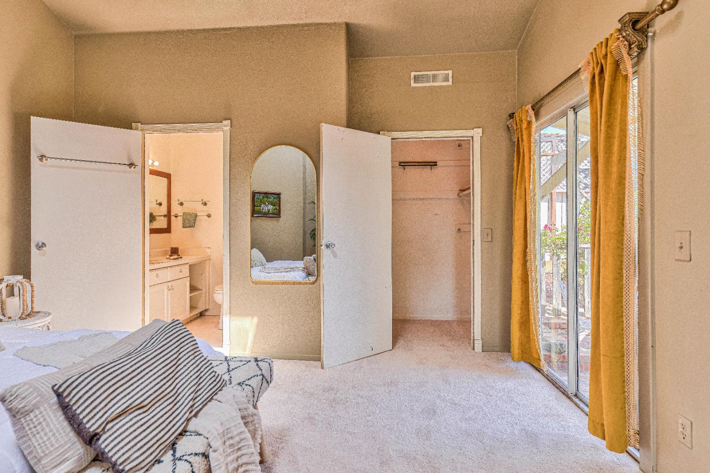 1868 Judson Street Seaside, CA 93955 - Photo 24 of 34 a bedroom with a bed and a mirror