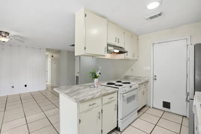 a kitchen with appliances a sink and cabinets