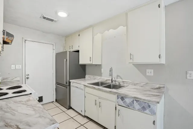 a kitchen with a sink cabinets and window