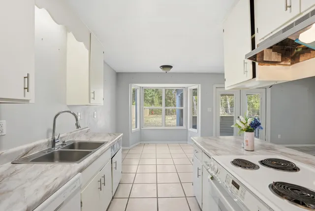 a view of a livingroom with an empty space and a window