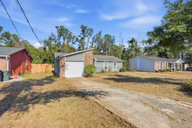 a view of a house with a yard and a garage