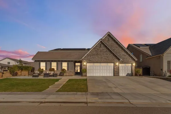 a front view of a house with a garden and porch