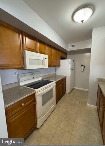 203 Gregorys Way Voorhees, NJ 08043 - Photo 4 of 10 a kitchen with a stove a sink and a refrigerator