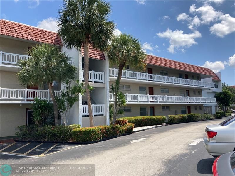 3541 Inverrary Drive, Unit 103 Lauderhill, FL 33319 - Photo 1 of 18 a front view of a building with garden