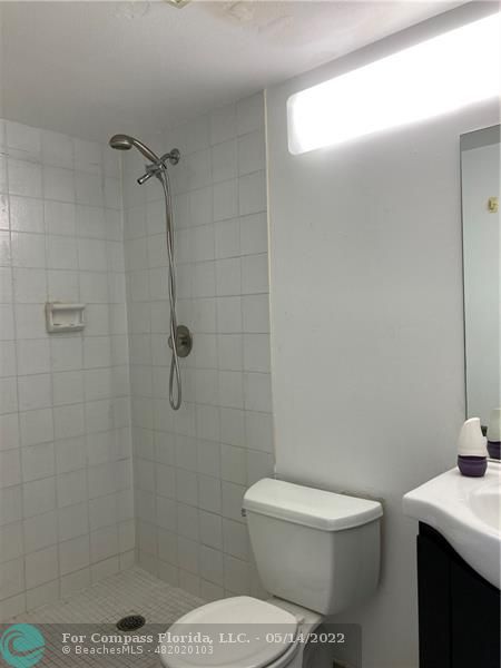 3541 Inverrary Drive, Unit 103 Lauderhill, FL 33319 - Photo 12 of 18 a white toilet sitting next to a shower