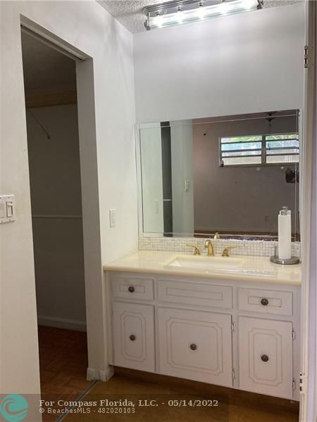 3541 Inverrary Drive, Unit 103 Lauderhill, FL 33319 - Photo 15 of 18 a bathroom with a sink and a mirror