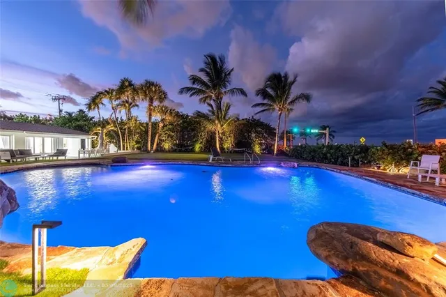 a view of swimming pool with outdoor seating