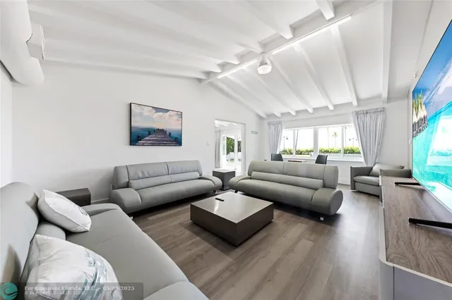 a living room with furniture or couch and a wooden floor