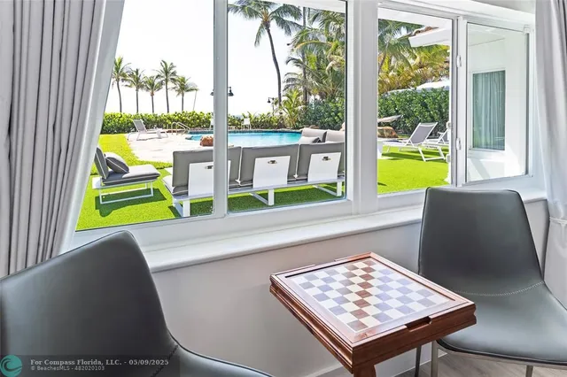 a view of a living room with a table and chair