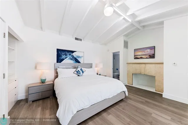 a bedroom with a bed and a fireplace