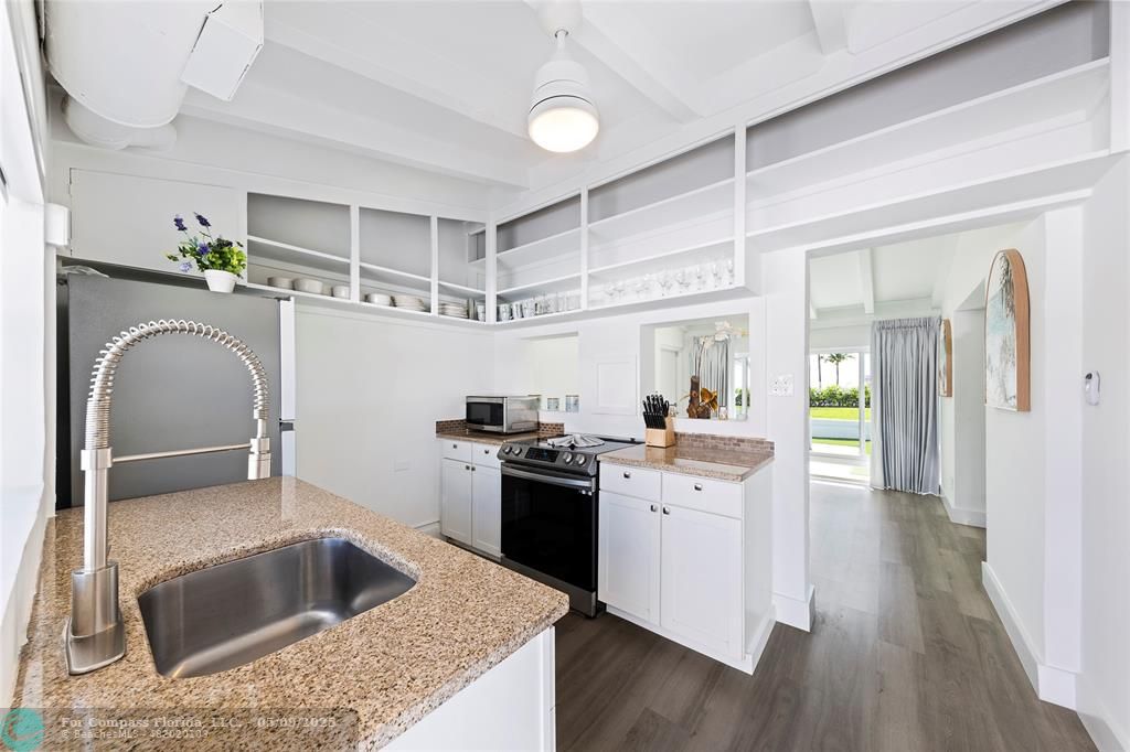 1663 North Fort Lauderdale Beach Boulevard Fort Lauderdale, FL 33305 - Photo 25 of 39 a kitchen with sink cabinets and wooden floor
