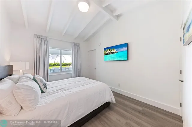 a bedroom with a bed and a painting on the wall