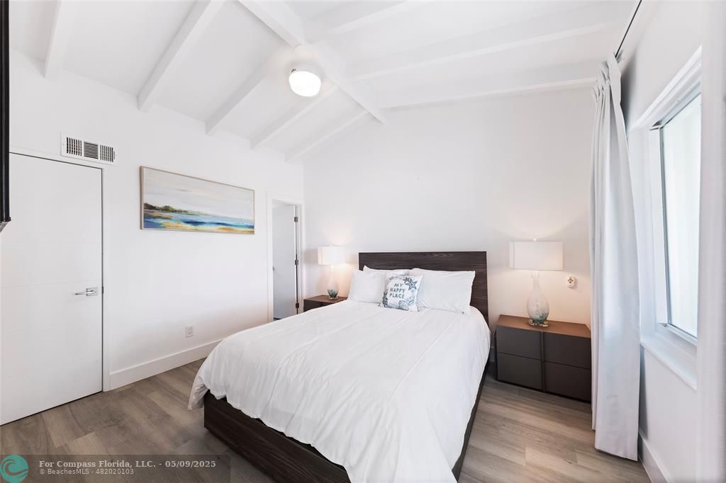 1663 North Fort Lauderdale Beach Boulevard Fort Lauderdale, FL 33305 - Photo 27 of 39 a bedroom with a bed and a cabinets