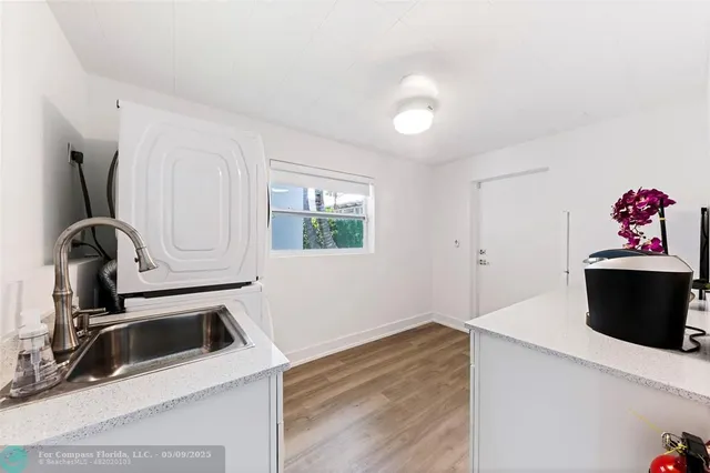 a view of a storage and utility room with a sink