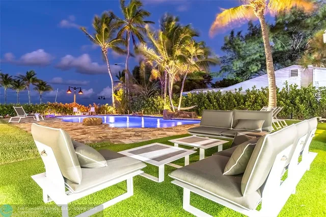a view of swimming pool with outdoor seating
