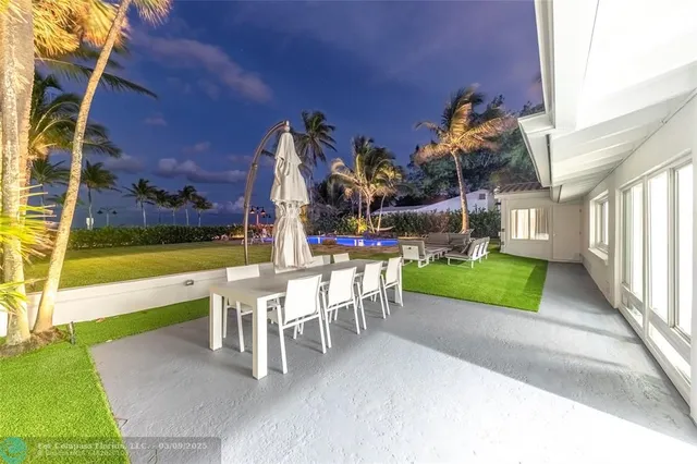 a view of a patio with table and chairs and potted plants
