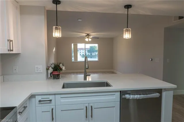 a kitchen with a sink and chandelier