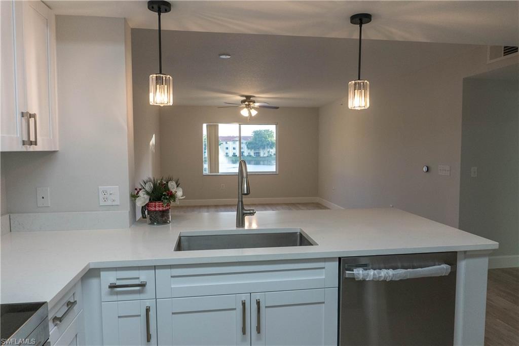 a kitchen with a sink and chandelier