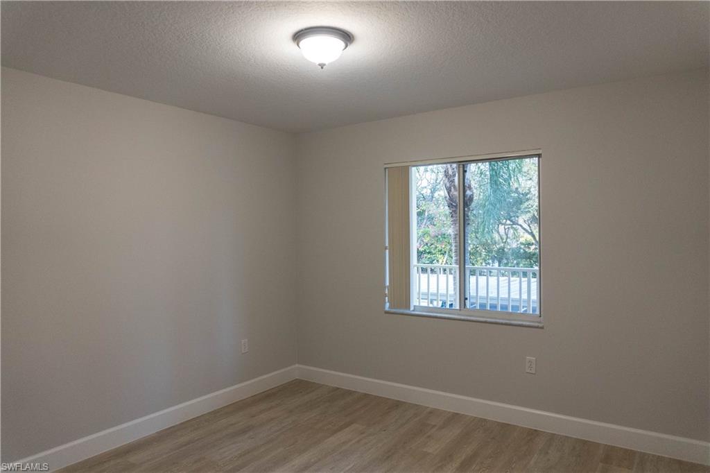 8234 Key Royal Circle, Unit 523 Naples, FL 34119 - Photo 17 of 20 an empty room with a window