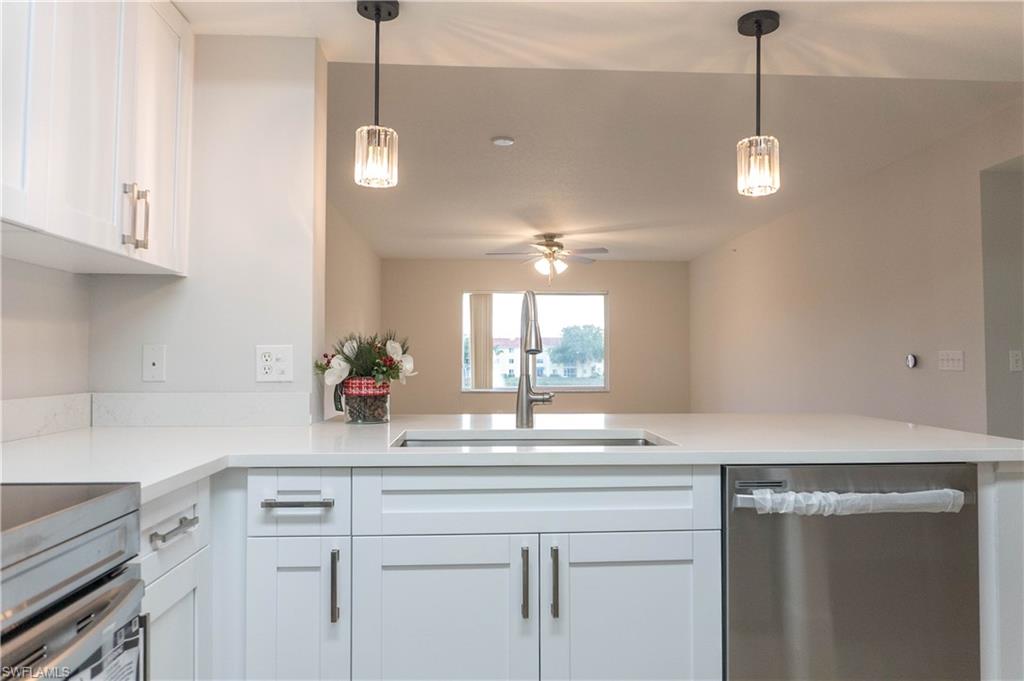8234 Key Royal Circle, Unit 523 Naples, FL 34119 - Photo 20 of 20 a kitchen with a sink and a refrigerator