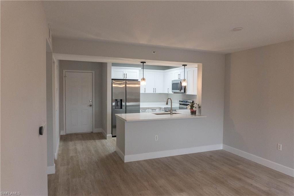 8234 Key Royal Circle, Unit 523 Naples, FL 34119 - Photo 5 of 20 a view of kitchen with wooden floor