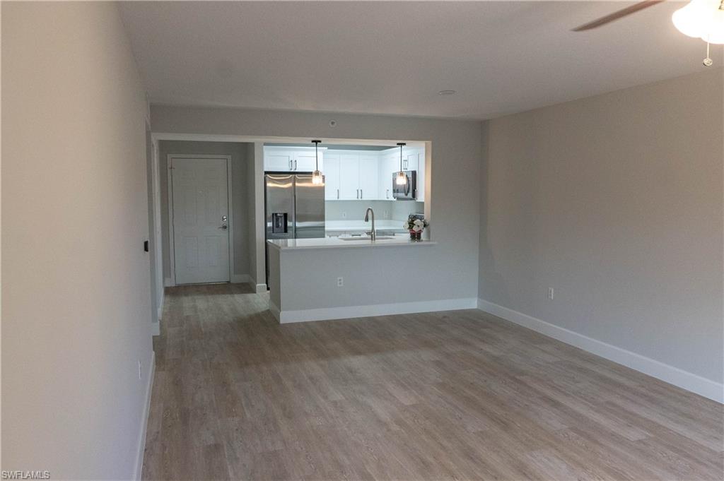 8234 Key Royal Circle, Unit 523 Naples, FL 34119 - Photo 6 of 20 a view of a kitchen with a sink and a window