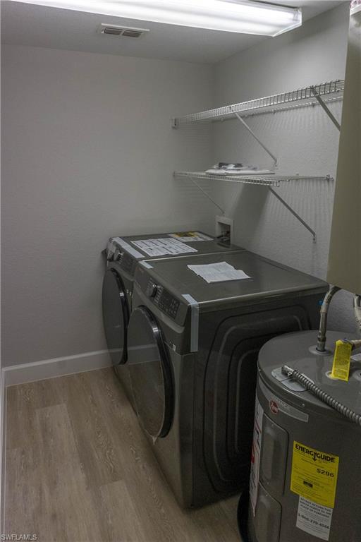 8234 Key Royal Circle, Unit 523 Naples, FL 34119 - Photo 10 of 20 a utility room with dryer and washer