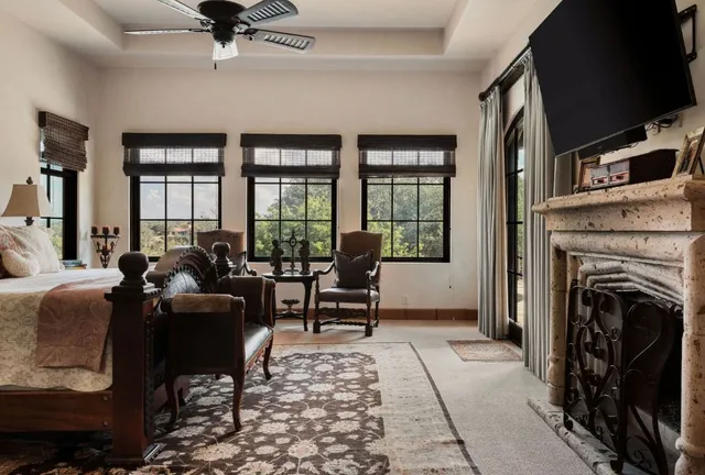 a living room with furniture a flat screen tv and a fireplace