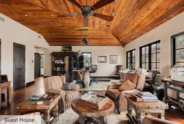 a living room with furniture and a ceiling fan