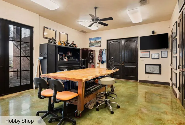 a room with table chairs and a flat screen tv