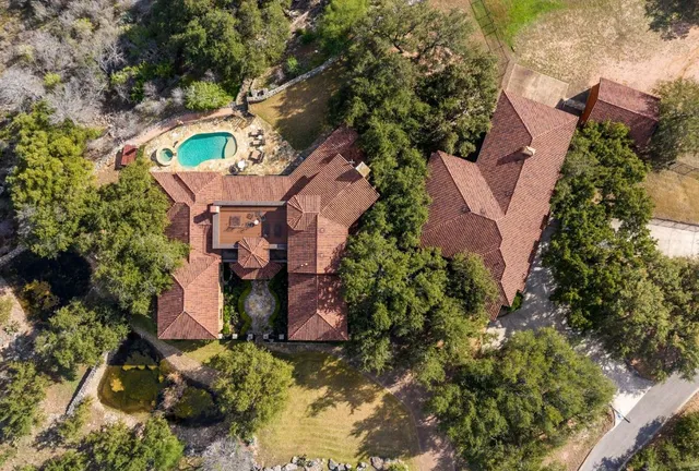 an aerial view of residential houses with outdoor space and mountain view