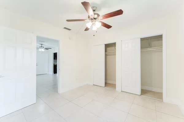 a view of an empty room with a ceiling fan
