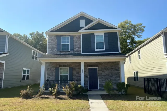 a front view of a house with yard and porch