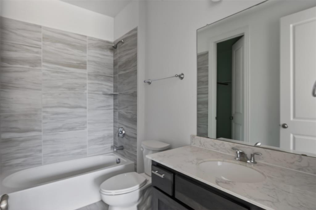 845 Ranchland Road Justin, TX 76247 - Photo 5 of 22 a bathroom with a sink a toilet and shower