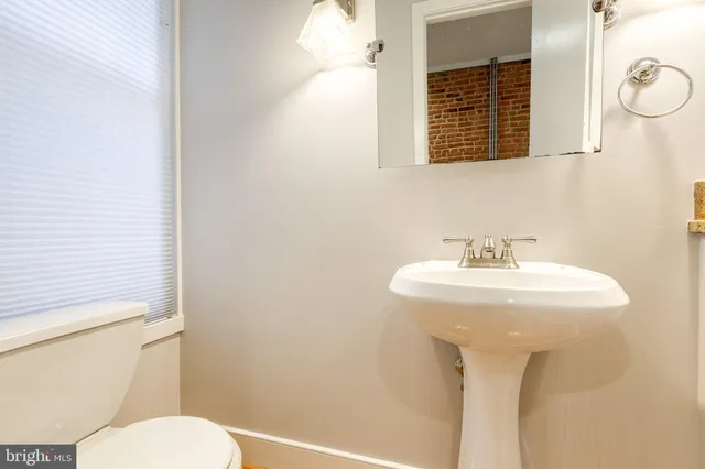 a kitchen with granite countertop a sink and cabinets