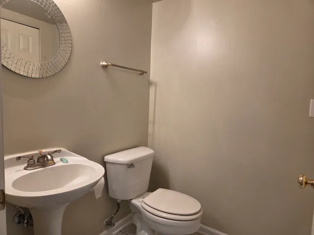 a white toilet sitting next to a bathroom sink