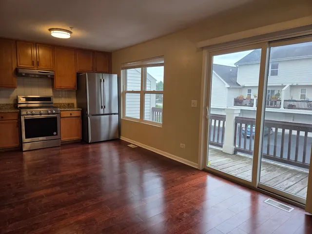 a kitchen with stainless steel appliances granite countertop a refrigerator microwave and stove